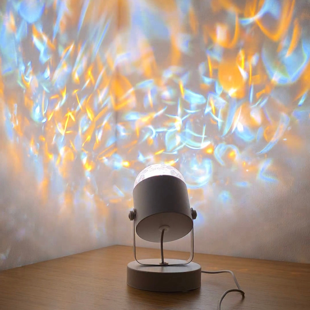 Ambient water ripple lamp creating relaxing blue and gold light reflections on wall and ceiling.